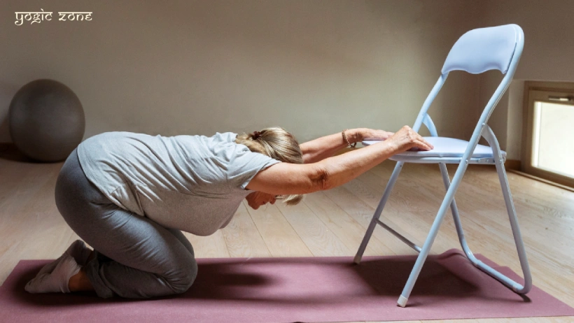 Chair yoga for seniors. A lady practicing yoga with the help of a chair. Blog by staging.yogiczone.com