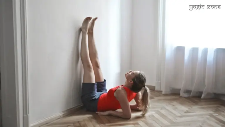A lady in a Viparita Karani pose. Blog by staging.yogiczone.com