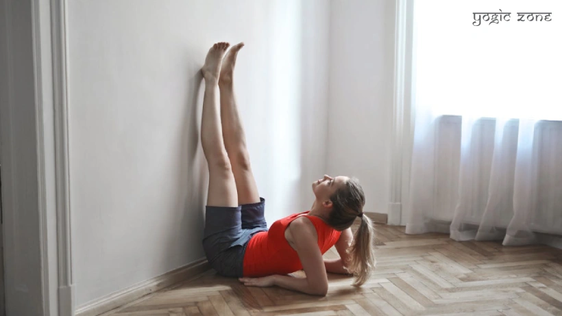 A lady in a Viparita Karani pose. Blog by staging.yogiczone.com