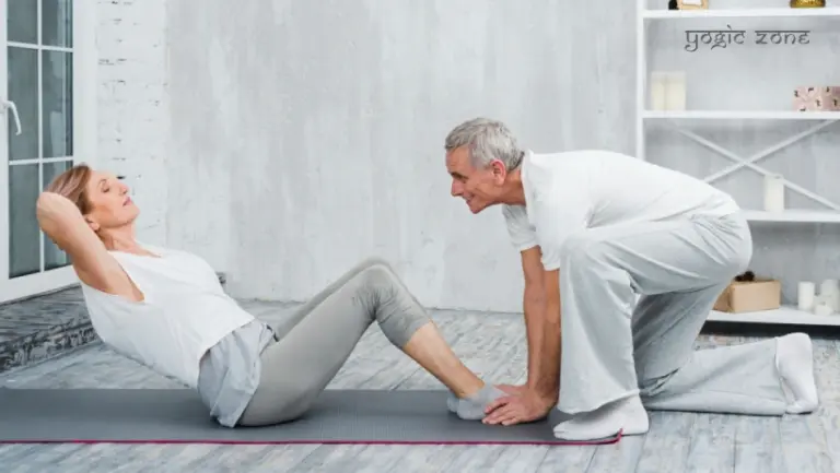 Seniors helping each other to practice Vinyasa Yoga for Seniors. blog by staging.yogiczone.com