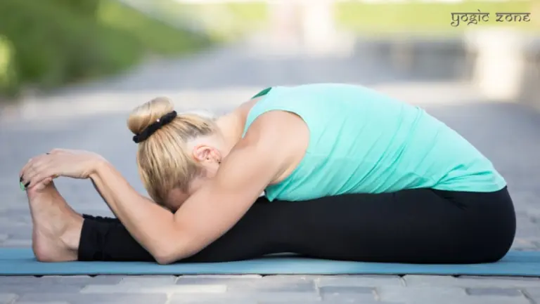 A lady performing the Paschimottanasana. Yoga for stress relief by staging.yogiczone.com