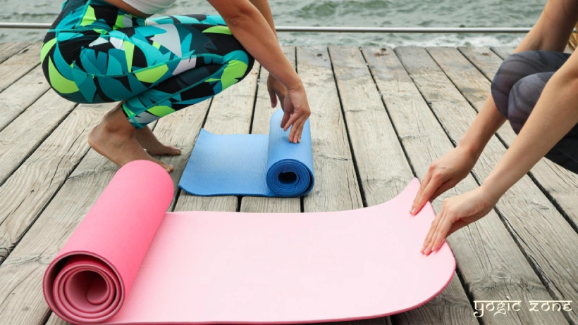Ladies rolling yoga mats. Blog on Yoga mat benefits by staging.yogiczone.com