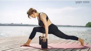 A lady in a balancing yoga pose. One of the yoga props benefits