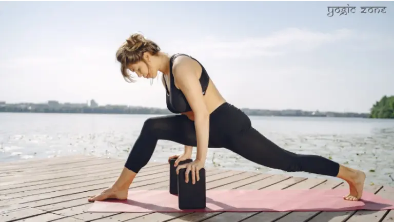 A lady in a balancing yoga pose. One of the yoga props benefits