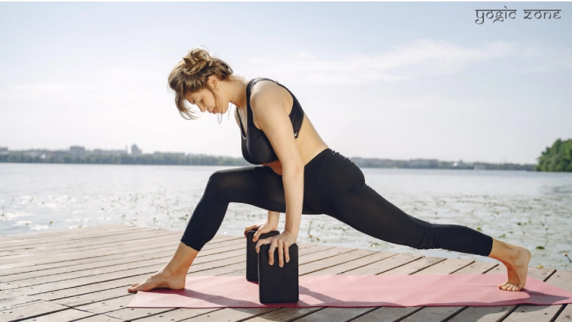 A lady in a balancing yoga pose. One of the yoga props benefits
